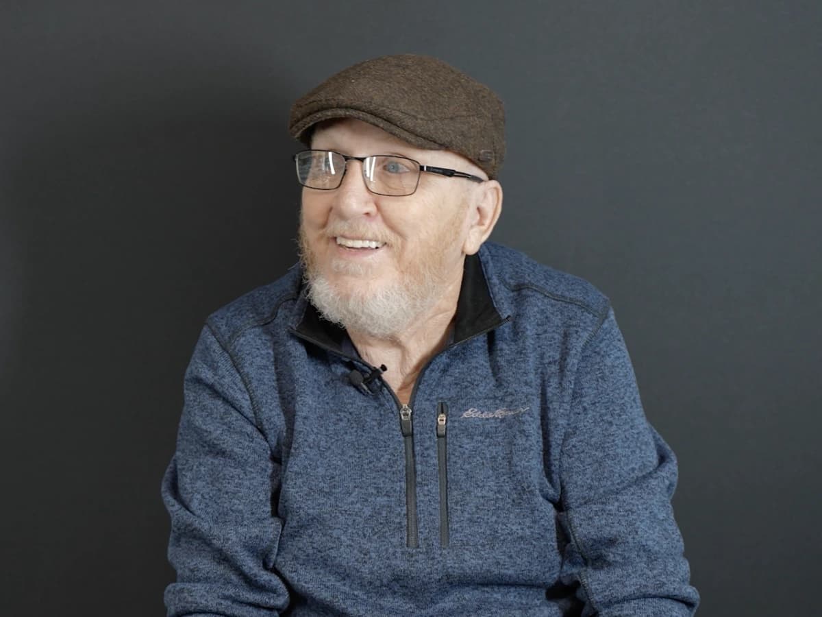 Patient smiling with snap-in implant dentures